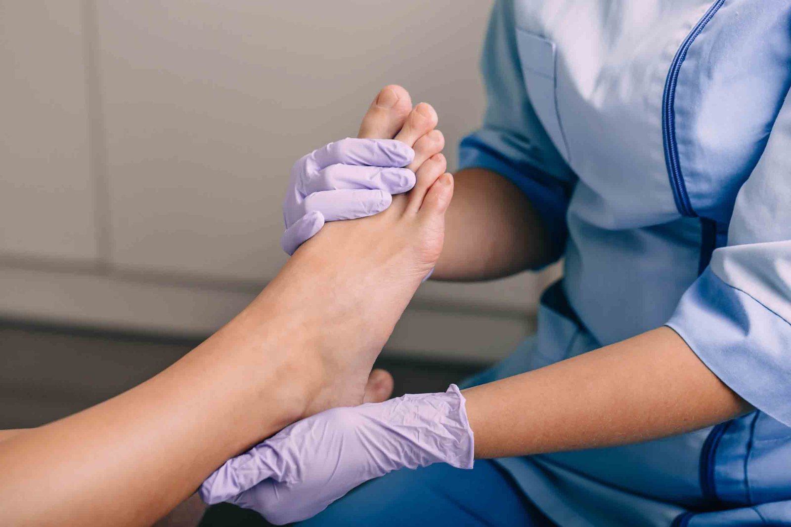 Podiatrist or physical therapist performing foot mobilization techniques (FMT) on a patient.